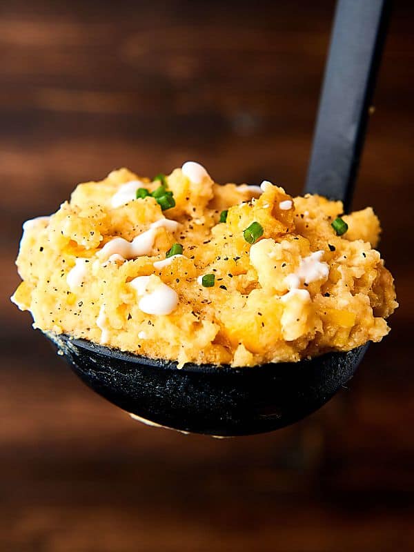 This Slow Cooker Corn Pudding is SO easy to make and is loaded with corn, cornbread mix, sour cream, cream cheese, cheddar cheese, and more! Perfect for the holidays! showmetheyummy.com