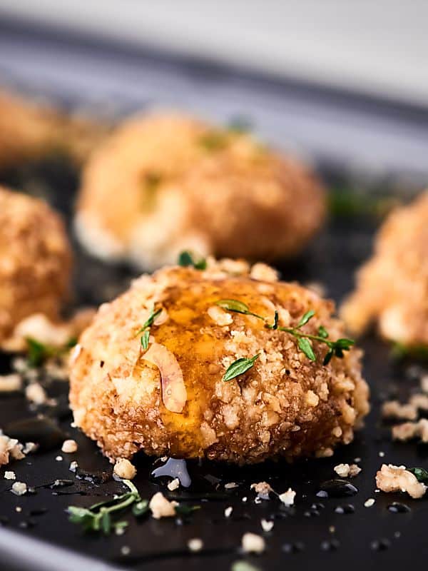 walnut goat cheese bites on baking sheet