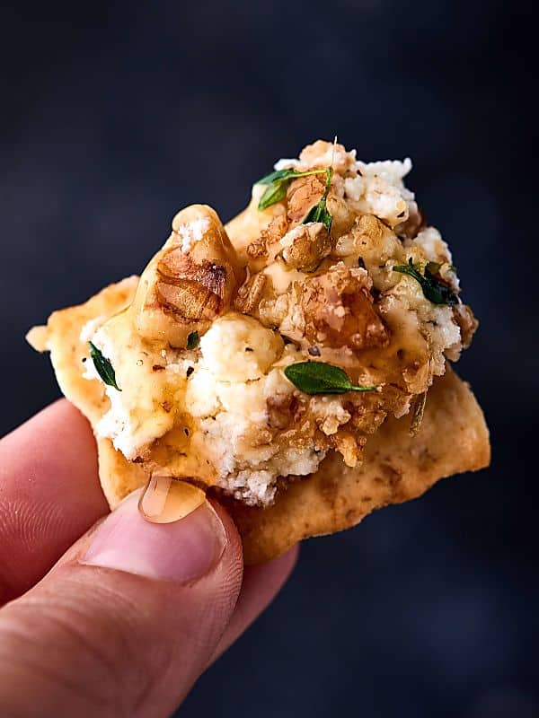 walnut goat cheese on cracker held