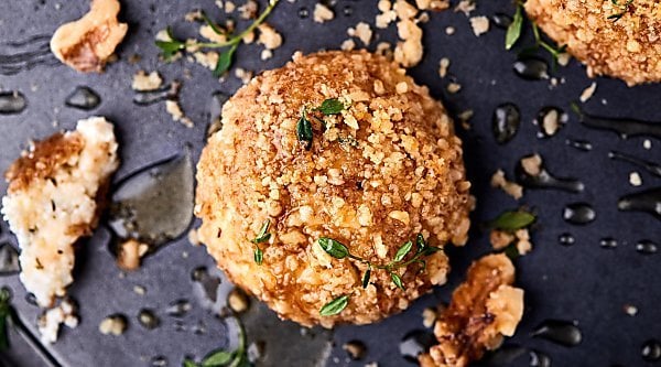 #ad Warm Walnut Goat Cheese Bites. Goat cheese mixed with honey and spices, rolled in crushed walnuts, and baked until warm! showmetheyummy.com Made in partnership w/ @CAWalnuts