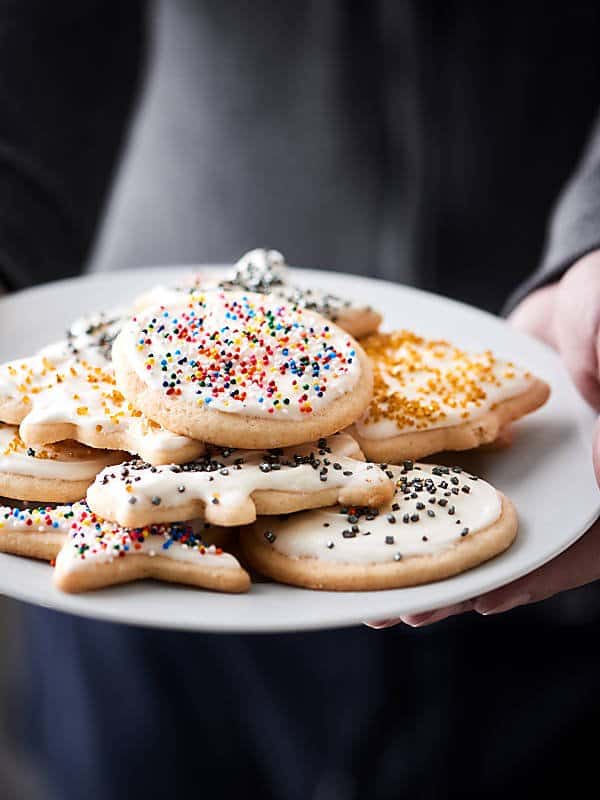 Cut out sugar cookies with cream cheese frosting! These are perfectly golden on the outside yet remain fluffy in the middle! showmetheyummy.com #sugarcookies #cookies