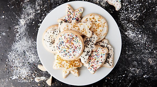 Cut out sugar cookies with cream cheese frosting! These are perfectly golden on the outside yet remain fluffy in the middle! showmetheyummy.com #sugarcookies #cookies