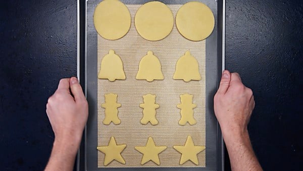 sugar cookie cut outs on baking sheet
