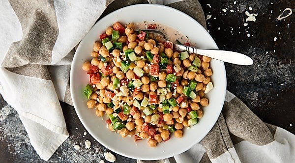 This Chopped Chickpea Greek Salad Recipe is the perfect vegetarian, gluten free light lunch or side dish! Full of chickpeas, chopped veggies, and smothered in a tangy greek yogurt and herb dressing! showmetheyummy.com #vegetarian #salad