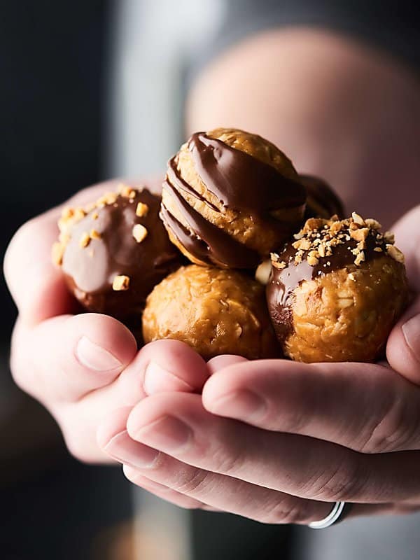 peanut butter energy bites held two hands