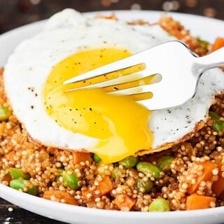 #ad This Quinoa Fried Rice Recipe is an easier, healthier version of a take out classic! Loaded with leftover quinoa, coconut oil, veggies, spices and more. Runny egg on top is optional, but highly recommended. ;) Gluten free. Dairy free. Can be vegan! showmetheyummy.com Made in partnership w/ @bobsredmill #quinoa #healthy