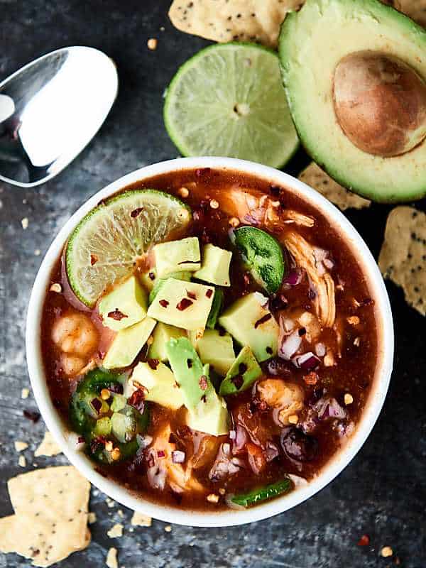 Enchiladas are now quicker, easier, and less messy with this Slow Cooker Enchilada Soup Recipe! Full of chicken, beans, and hominy, this recipe is healthy and delicious! 5 minutes of prep. Gluten free. showmetheyummy.com #enchilada #crockpot