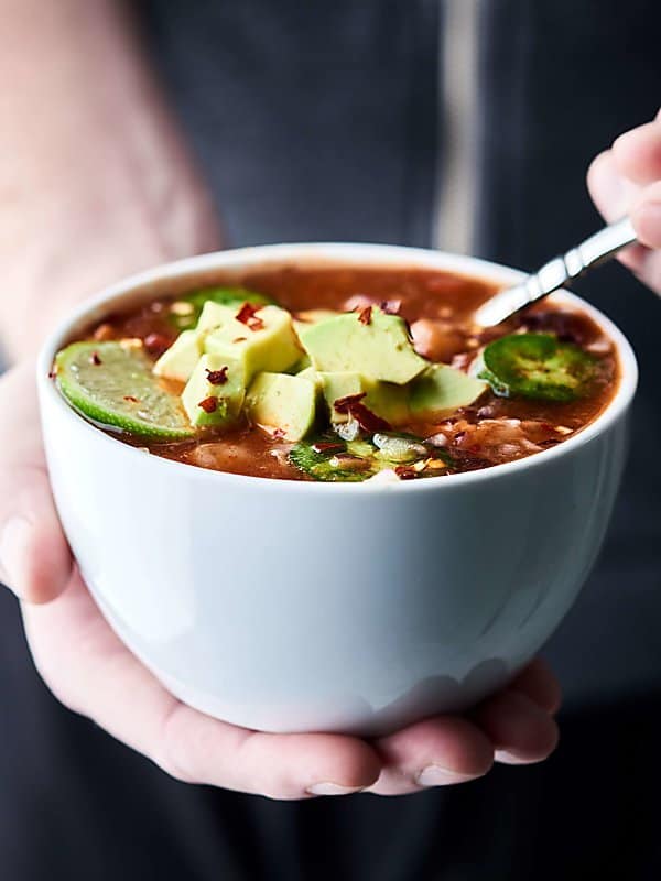 bowl of enchilada soup held