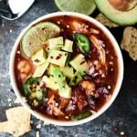 Enchiladas are now quicker, easier, and less messy with this Slow Cooker Enchilada Soup Recipe! Full of chicken, beans, and hominy, this recipe is healthy and delicious! 5 minutes of prep. Gluten free. showmetheyummy.com #enchilada #crockpot