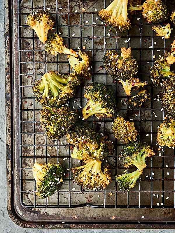 Roasted broccoli turned up a notch, this Asian Roasted Broccoli Recipe is healthy and full of coconut oil, soy sauce, spices, and just a touch of sriracha! Vegan. Can be gluten free. showmetheyummy.com #broccoli #vegan #glutenfree