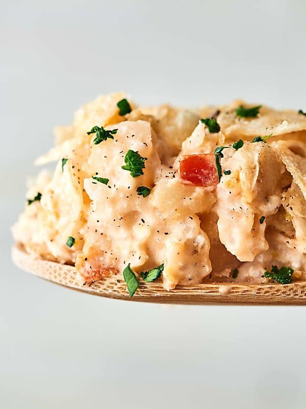 Crockpot funeral potatoes on wooden spoon