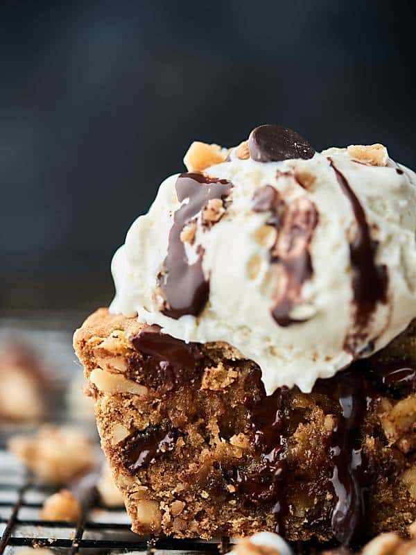 deep dish walnut chocolate chip cookie piece topped with ice cream