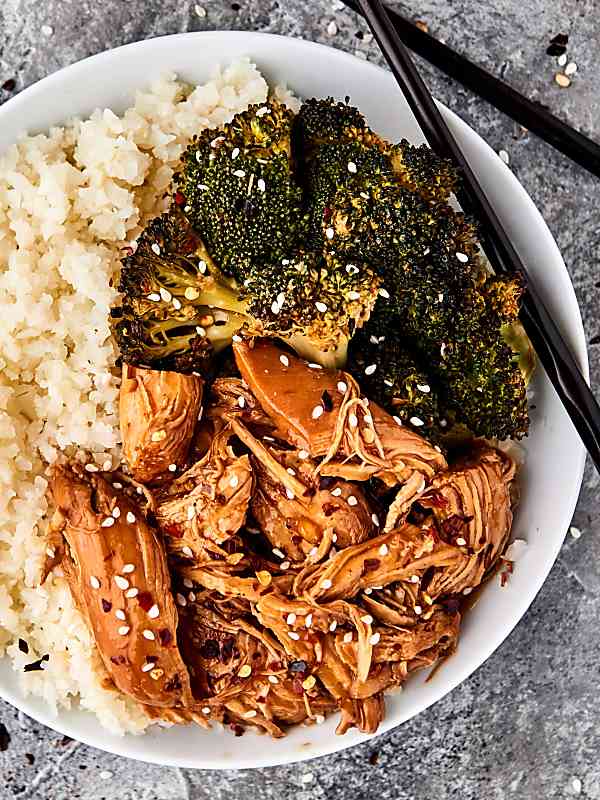 Instant pot orange chicken on a plate with broccoli and rice above