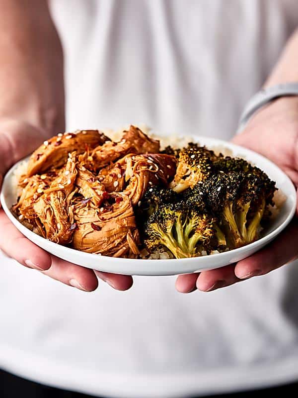 Instant pot orange chicken on a plate with broccoli held