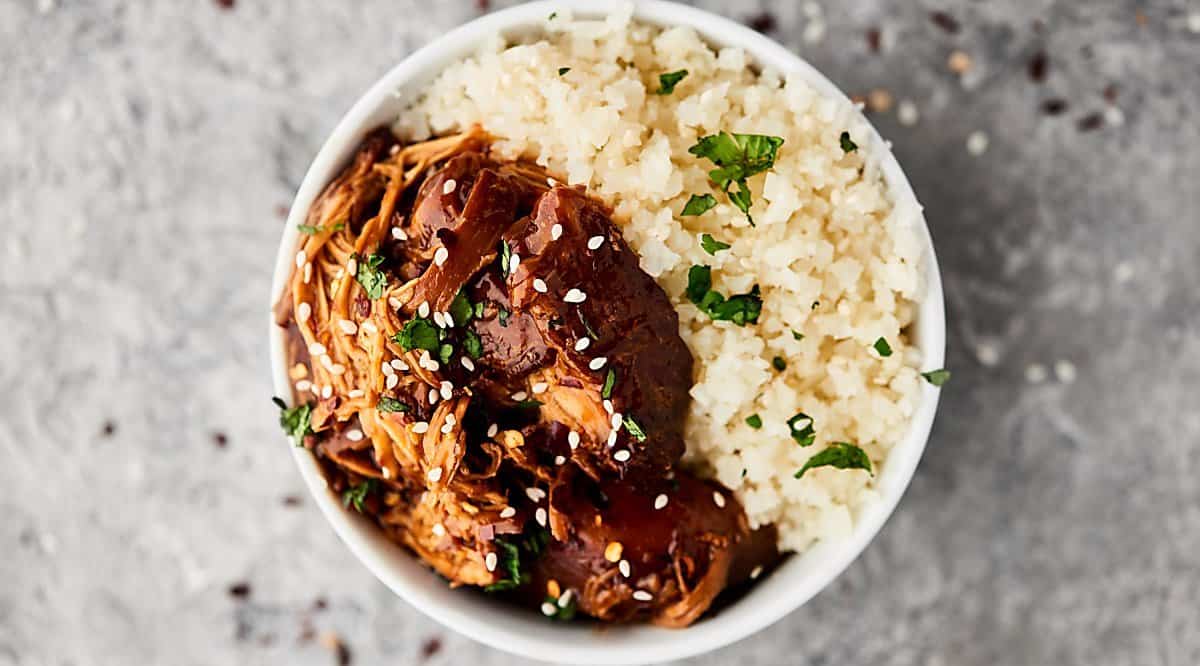 Bowl of teriyaki chicken with rice above