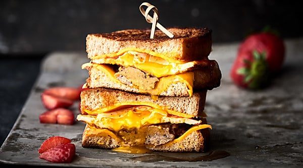 #ad Breakfast Grilled Cheese. A classic grilled cheese sandwich loaded with a gooey fried egg, savory sausage, and a generous drizzle of maple syrup! showmetheyummy.com Made in partnership w/ @SaraLeeBread #saraleebread #artesanobread #artesanogoldenwheat