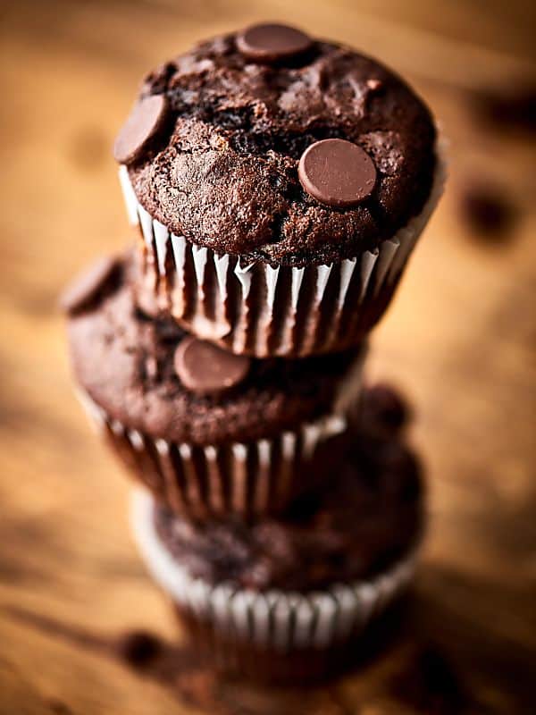 Four double chocolate banana muffins stacked