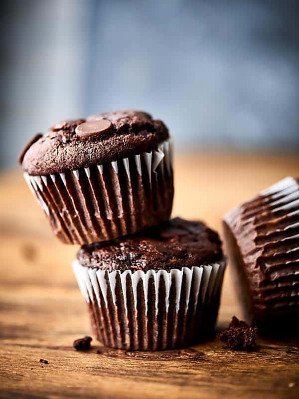 Two double chocolate banana muffins stacked