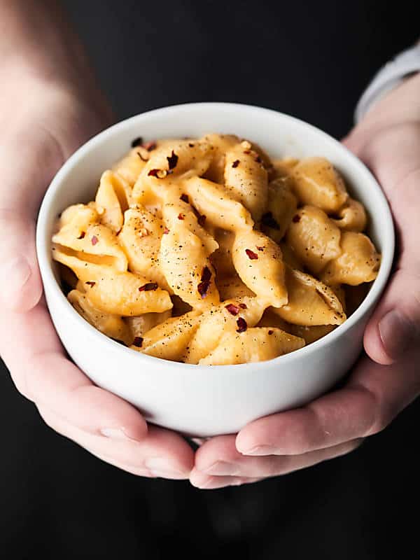 This Instant Pot Mac and Cheese Recipe only requires a few minutes and a few ingredients: pasta shells, broth, salt, pepper, milk, parmesan, gruyere, and sharp cheddar cheese to make! showmetheyummy.com #instantpot #macandcheese