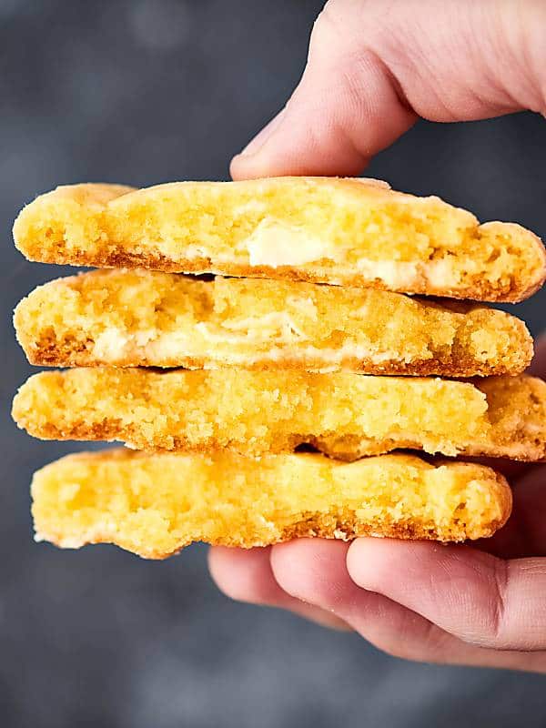 A spring twist on a chocolate classic, these lemon crinkle cookies are bright, lemon-y, and perfectly sweet! My secret ingredient? Lemon pudding mix and white chocolate! showmetheyummy.com #lemon #cookies