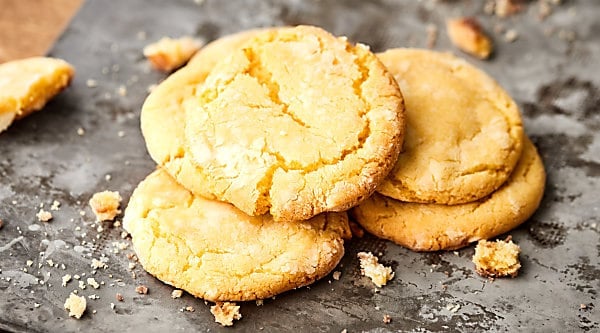 A spring twist on a chocolate classic, these lemon crinkle cookies are bright, lemon-y, and perfectly sweet! My secret ingredient? Lemon pudding mix and white chocolate! showmetheyummy.com #lemon #cookies