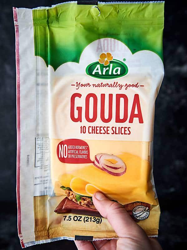 package of sliced gouda cheese held