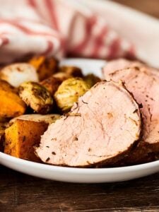 This Pork Tenderloin Recipe is quick, easy, healthy, and so tasty! Loaded with pork, sweet potatoes, brussels sprouts, onion, and apples, and smothered in balsamic vinegar and spices: garlic, rosemary, thyme, paprika, salt, and pepper! showmetheyummy.com #sheetpandinner #porktenderloin