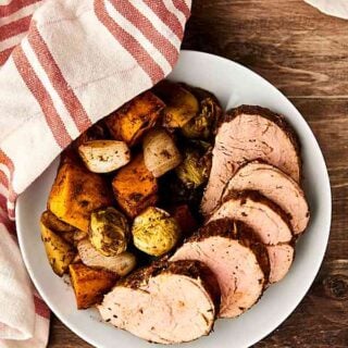 This Pork Tenderloin Recipe is quick, easy, healthy, and so tasty! Loaded with pork, sweet potatoes, brussels sprouts, onion, and apples, and smothered in balsamic vinegar and spices: garlic, rosemary, thyme, paprika, salt, and pepper! showmetheyummy.com #sheetpandinner #porktenderloin