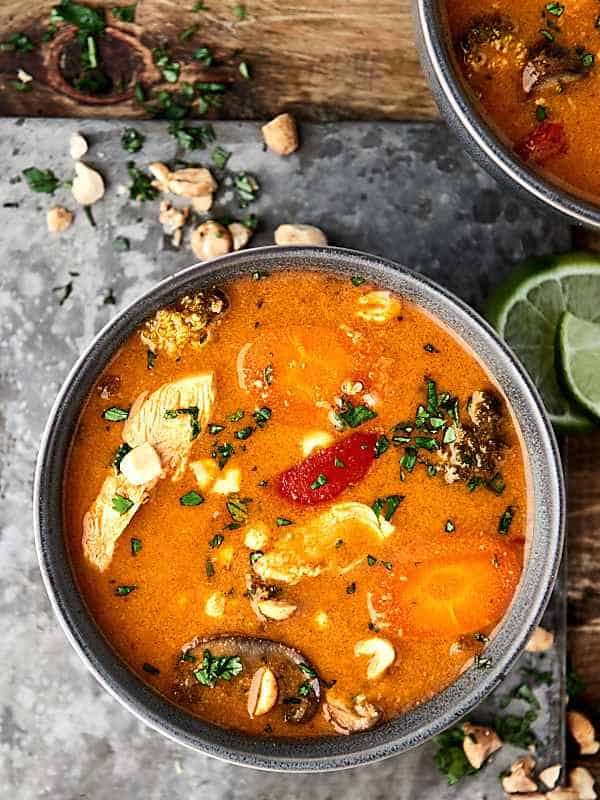 Slow cooker thai chicken soup in a bowl held