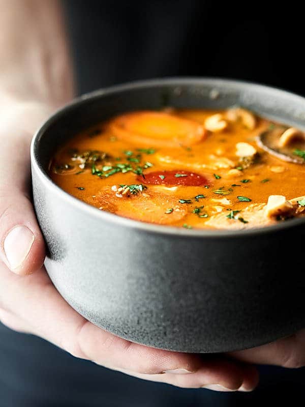 This Slow Cooker Thai Chicken Soup is loaded with creamy coconut milk, peanut butter, red curry paste, chicken, and veggies: onion, carrots, bell pepper, mushrooms, and broccoli! PACKED with flavor and healthy deliciousness! Less than 250 calories per cup! showmetheyummy.com #crockpot #chickensoup