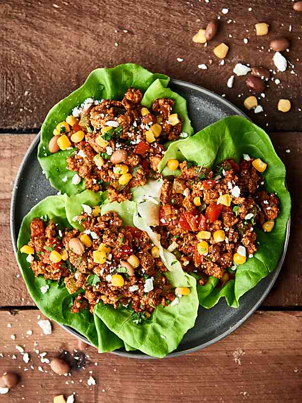 Three lettuce wrap turkey tacos on a plate from above