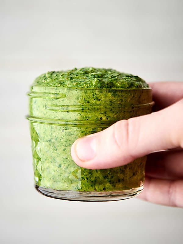 jar of arugula walnut pesto held