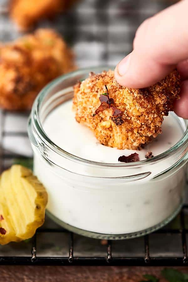 Chicken nugget being dipped in jar of ranch