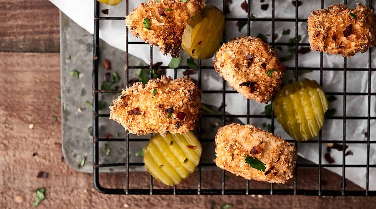 Chicken nuggets on cooling rack above