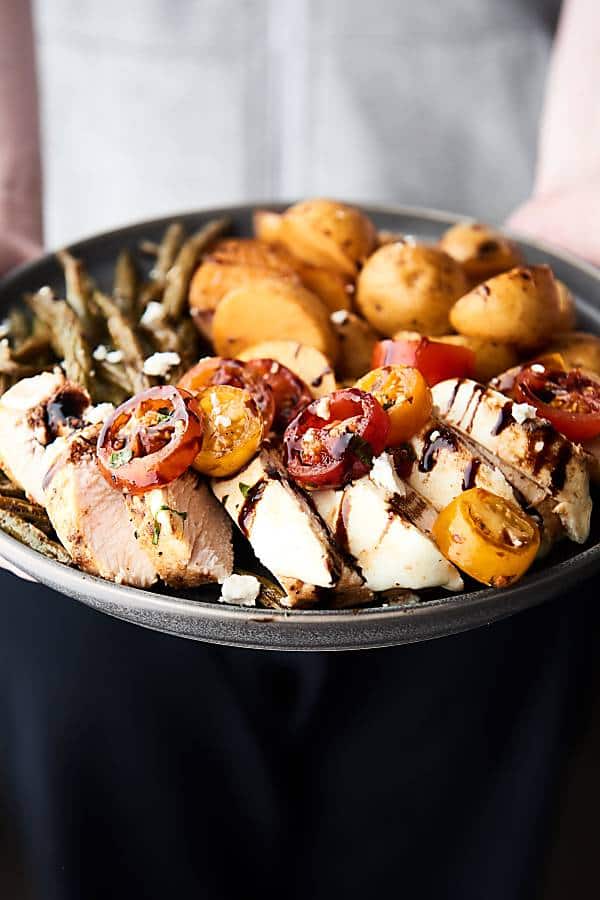 plate of bruschetta chicken held