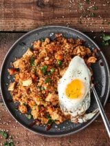 A healthy version of a take out classic, you're going to LOVE this Chicken Cauliflower Fried Rice Recipe. Super quick, easy, healthy, and of course delicious! A new low carb favorite. Loaded with pre-made frozen riced cauliflower and all your favorite fried rice flavors! showmetheyummy.com #chicken #friedrice #cauliflower #healthy