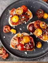 This easy bruschetta recipe is a healthy summer classic! Juicy tomatoes tossed with sun dried tomatoes, garlic, a touch of oil, balsamic vinegar, and fresh basil . . . we can't get enough of this stuff! showmetheyummy.com #bruschetta #summerrecipe #healthy #vegan