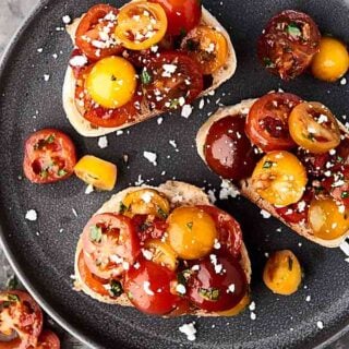 This easy bruschetta recipe is a healthy summer classic! Juicy tomatoes tossed with sun dried tomatoes, garlic, a touch of oil, balsamic vinegar, and fresh basil . . . we can't get enough of this stuff! showmetheyummy.com #bruschetta #summerrecipe #healthy #vegan