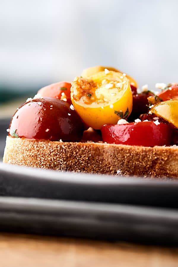 This easy bruschetta recipe is a healthy summer classic! Juicy tomatoes tossed with sun dried tomatoes, garlic, a touch of oil, balsamic vinegar, and fresh basil . . . we can't get enough of this stuff! showmetheyummy.com #bruschetta #summerrecipe #healthy #vegan