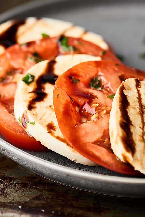 Caprese salad on plate with balsamic glaze