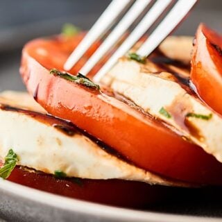 Mozzarella and tomato with fork closeup