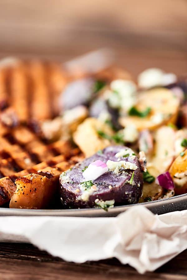 closeup of plate with grilled potatoes and pork chops