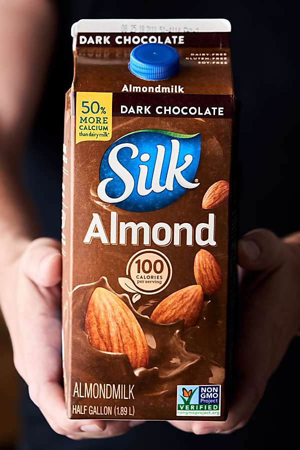 carton of Silk dark chocolate almond milk held