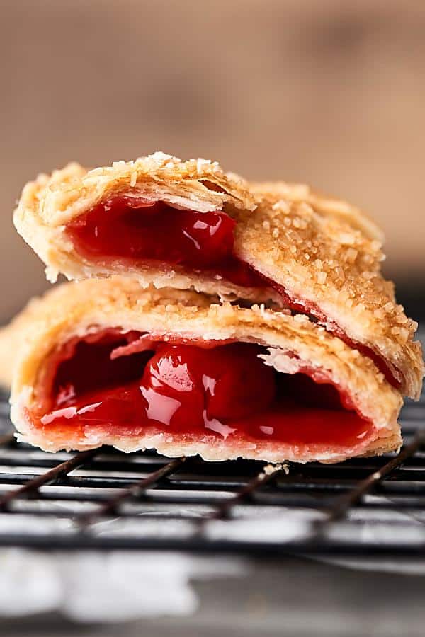 These Air Fryer Hand Pies are SO quick and easy to make. We're making 4 flavors today: S'Mores, Blueberry, Caramel Apple, and Cherry! I used store-bought crust and fillings to make this ULTRA easy, but feel free to make your own homemade crust and fillings! showmetheyummy.com #airfryer #handpies #cherry #smores #blueberry #apple #caramel #nutella