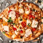 Easy Thai Chicken Naan Pizza Recipe. Store bought naan topped with a homemade easy peanut sauce, monterey jack cheese, chicken, carrots, peppers, cilantro, green onion, and peanuts! SO quick and delicious! showmetheyummy.com #naan #pizza #thai #chicken