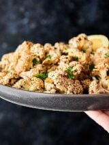 This Mediterranean Roasted Cauliflower Recipe is healthy, gluten free, can be vegan, and is absolutely delicious! Marinated in lemon juice, balsamic vinegar, and spices: salt, basil, garlic powder, onion powder, pepper, oregano, and thyme all day and roasted to perfection. Quick and easy vegetable side dish! showmetheyummy.com #mediterranean #roastedcauliflower