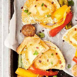 #ad Sheet Pan Pierogies with Sausage and Peppers. Garlic and parmesan pierogies baked until crispy with beer brats, peppers, and onions! A quick and easy family dinner that is sure to be a crowd favorite! showmetheyummy.com Made in partnership w/ @easyhomemeals #sheetpan #dinner #pierogies #sausage #peppers