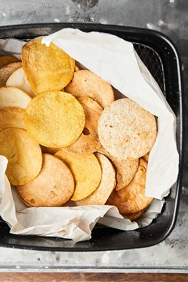 Air fryer tortilla chips in air fryer basket above