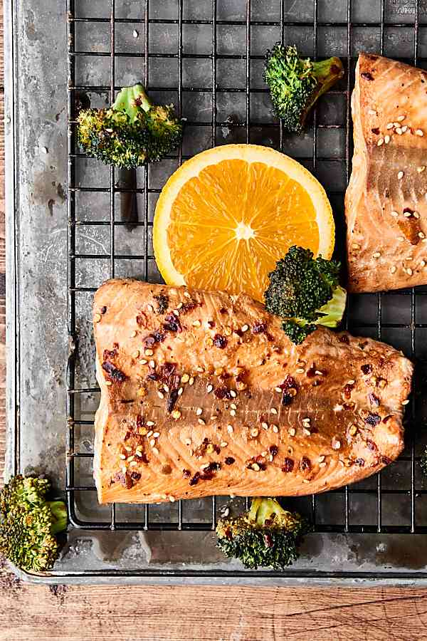 asian salmon and broccoli on cooling rack above