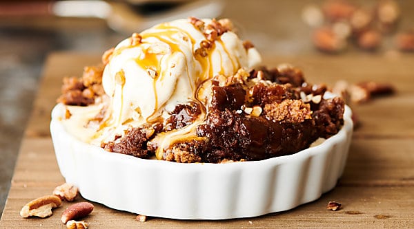 Crockpot Pumpkin Dump Cake. An easy homemade pumpkin pie filling made with pumpkin, brown sugar, vanilla, cinnamon, ginger, cloves, nutmeg, and salt gets topped with caramel, pecans, spice cake mix, and butter. Don't forget to serve it warm with a scoop of vanilla ice cream! showmetheyummy.com #crockpot #pumpkin #dumpcake #pie